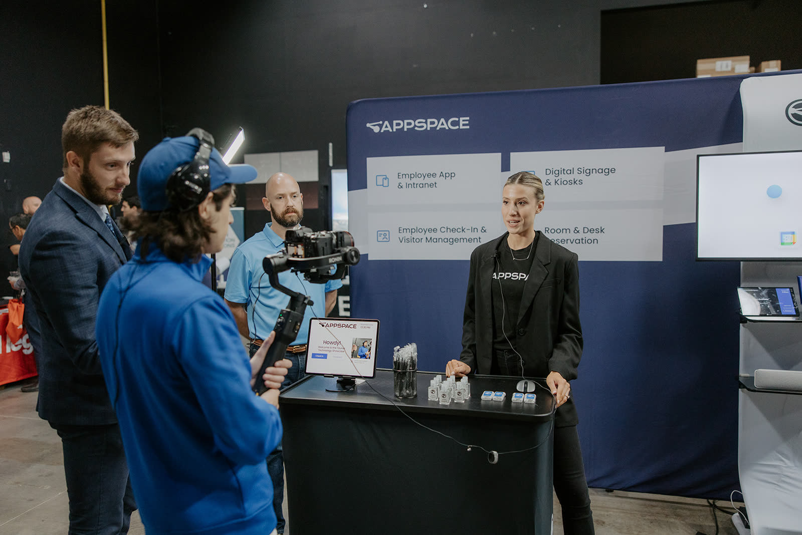 A video crew filming a booth presentation